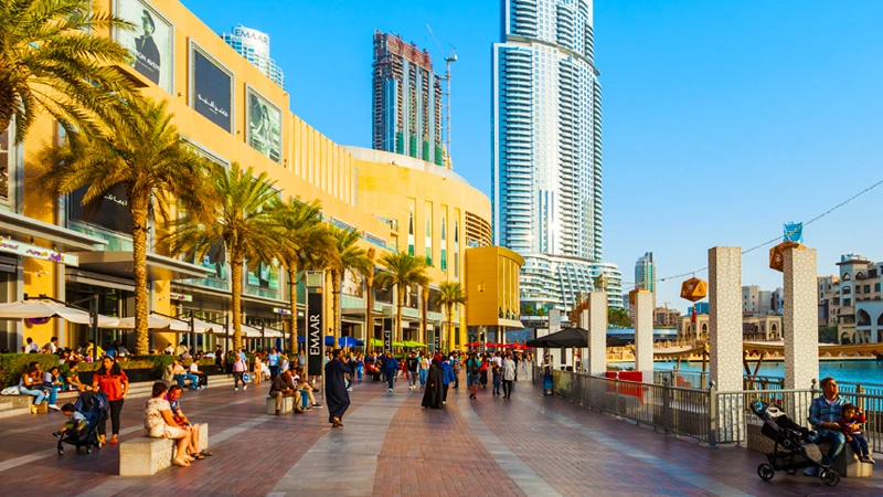 Dubai Mall exterior with modern architecture and surrounding city skyline in downtown Dubai.