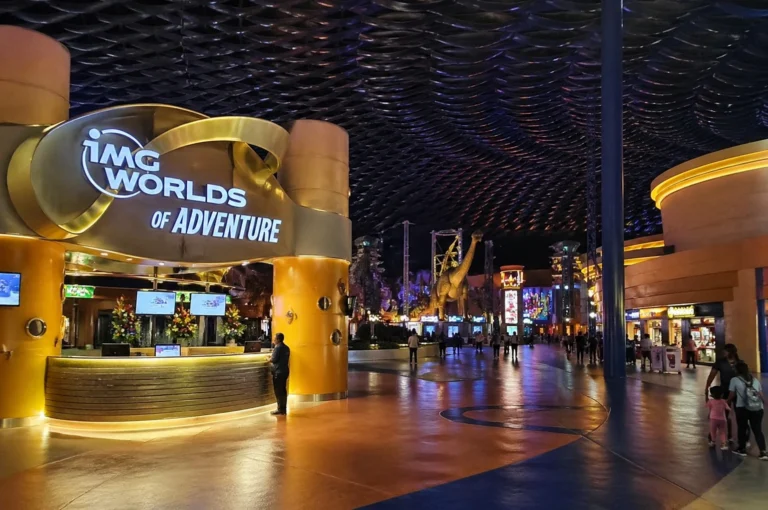 IMG Worlds of Adventure Dubai entrance with illuminated signage and indoor theme park interior